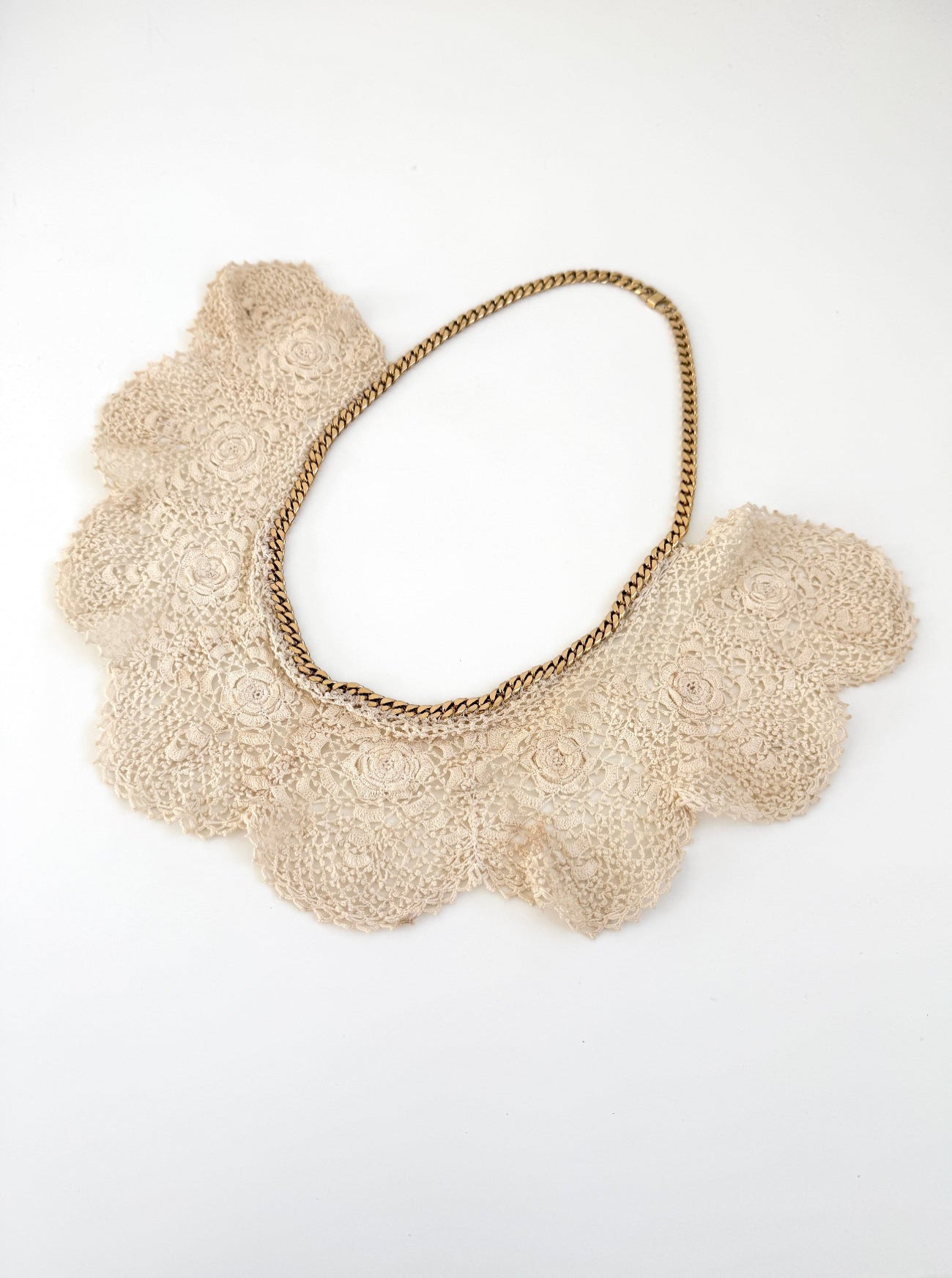 Beige lace collar necklace on a white background