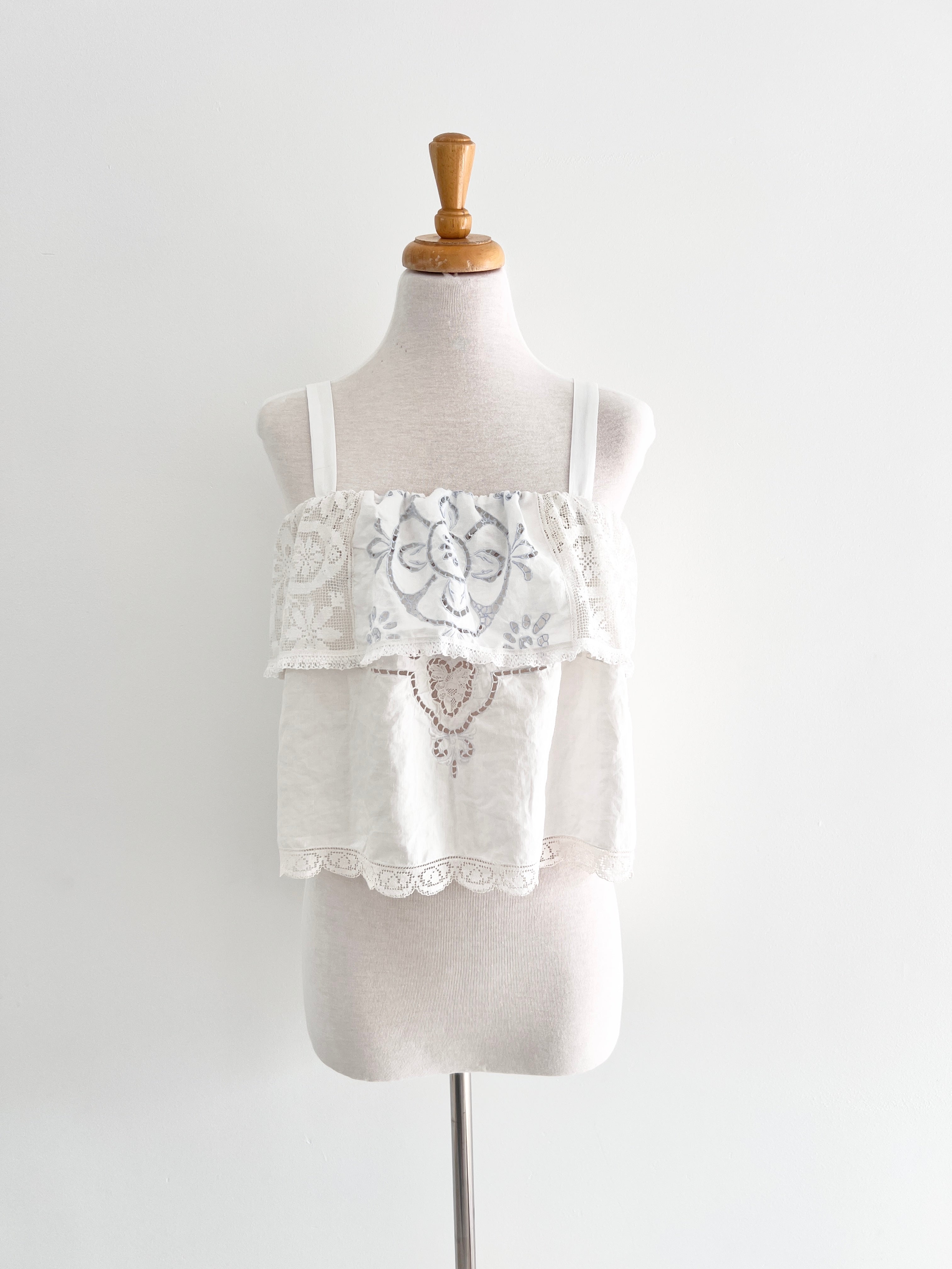 White lace dress on a mannequin against a white background